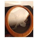 wood framed oval mirror with eagle etched on it