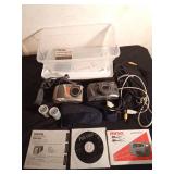 2 vintage cameras, manuals, straps, cords, and 2 rolls of vintage film