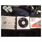 2 vintage cameras, manuals, straps, cords, and 2 rolls of vintage film