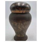 Bronze jar with rounded body and domed lid.