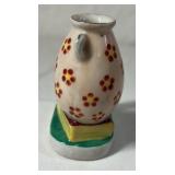 Occupied Japan Porcelain Figurine – Cherub Leaning on Vase with Flowers