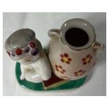 Occupied Japan Porcelain Figurine – Cherub Leaning on Vase with Flowers