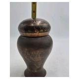 Bronze jar with rounded body and domed lid.