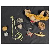 Lot of Costume Jewelry including Beaded Necklace, Gold Brooch, and Decorative Belt
