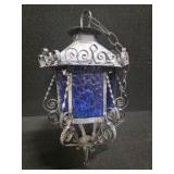 Vintage Hanging Lantern featuring a Decorative Wrought Iron Frame and Textured Blue-Glass Panels