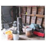 Contents of corner including buckets, a wood barrel, tar paper, motor and more