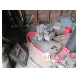 Contents of corner including buckets, a wood barrel, tar paper, motor and more