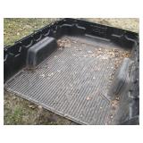 Rugged Liner branded truck bed line...