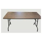 Stylish table with a wood-like surface and metal legs, measuring 59.5 x 30 inches.