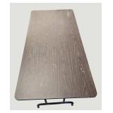 Stylish table with a wood-like surface and metal legs, measuring 59.5 x 30 inches.