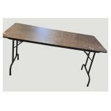 Stylish black table with a sturdy wood-like surface and chic metal legs, measuring 59.5 x 30 inches.