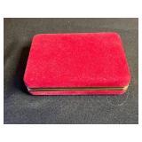 Vintage assorted earrings and jewelry components in red velvet box