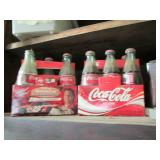2 Packs of Coca Cola bottles, some ...