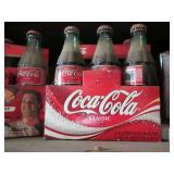 2 Packs of Coca Cola bottles, some ...
