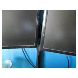 Pair of Samsung monitors with a sta...