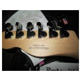 Squire electric guitar in a hardshe...