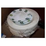 Stack of dinner plates and decorati...