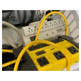 Assorted Power Strips Surge Protectors Extension Cords Basket with Tripp Lite Outlet Bar