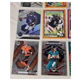 Lot of 24 Inserts and Relic Football Cards Featuring Players Like Lamar Jackson, Justin Herbert, and Trevor Lawrence. Includes Rookie Cards and Special Inserts.