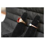 Ladies rings, one with red stone is...