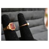 Ladies rings, one with red stone is...