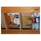 Christmas dishes in both cupboards...