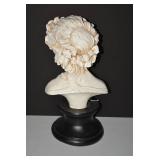 Bust of young maiden with leaves an...