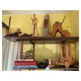 Wood carvings and books, all on 2 s...