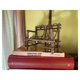 Wood carvings and books, all on 2 s...