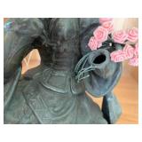 Bronze-colored seated woman figure...