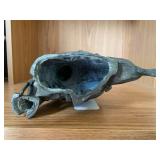 Bronze-colored seated woman figure...