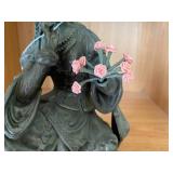 Bronze-colored seated woman figure...