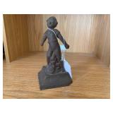 Cast iron door stop of child...