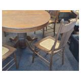Vintage Clawfoot Wood Dining Table with (4) Wicker Seat Side Chairs