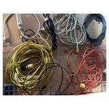 collection of various electrical extension cords and a power strip