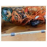 Wood box with electrical cords, battery tender and power strip.