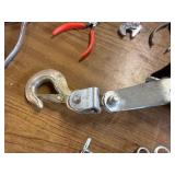 Box of tools including a come along and various hardware ect