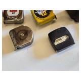 Lot of Hand Tools including Tape Measures, Metal Clamp, and Metal Holder