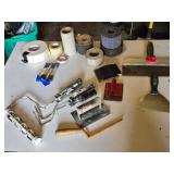 Drywall Tools and Supplies including Rolls of Tape, Trowels, and Sanding Tools