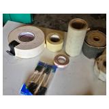 Drywall Tools and Supplies including Rolls of Tape, Trowels, and Sanding Tools