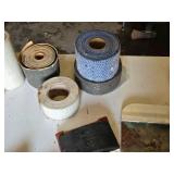 Drywall Tools and Supplies including Rolls of Tape, Trowels, and Sanding Tools