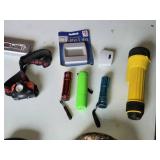 Lot of Flashlights and Headlamps Including Rechargeable LED Safety Lights, Black & Decker Work Light, and Accessories