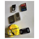Various Vintage Electronic Gadgets Including Palm V PDA, Pocket Keno Game, and Other Handheld Devices