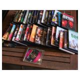 Lot of DVDs and CDs including Ted, Last Man Standing, and Journey to Adventure CD-ROM