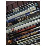 Lot of DVDs and CDs including Ted, Last Man Standing, and Journey to Adventure CD-ROM