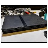Sony PlayStation 2 Slim console bundle including controllers, cables, and accessories