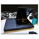 Sony PlayStation 2 Slim console bundle including controllers, cables, and accessories
