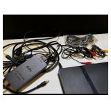 Sony PlayStation 2 Slim console bundle including controllers, cables, and accessories