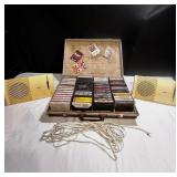 Vintage Bose speaker set with briefcase filled with cassette tapes