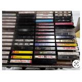 Vintage Bose speaker set with briefcase filled with cassette tapes